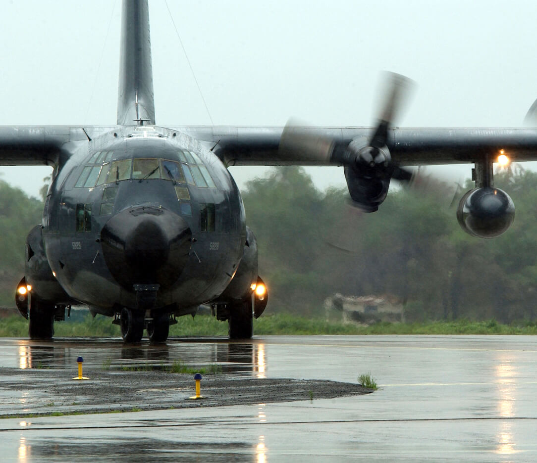 C-130 on a rain slicked runway.