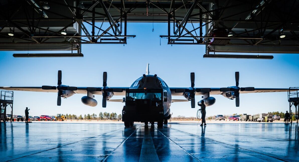A C-130 sitting in a hanger.