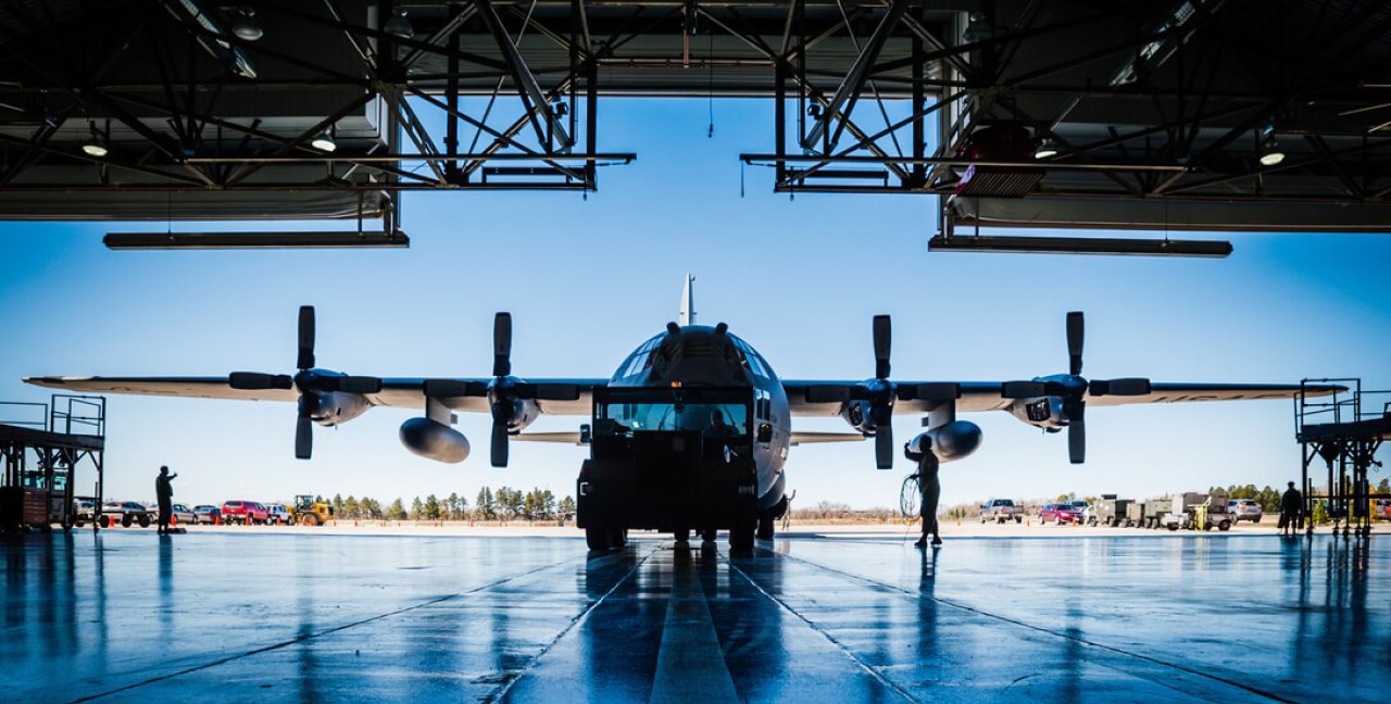 A C-130 sitting in a hanger.