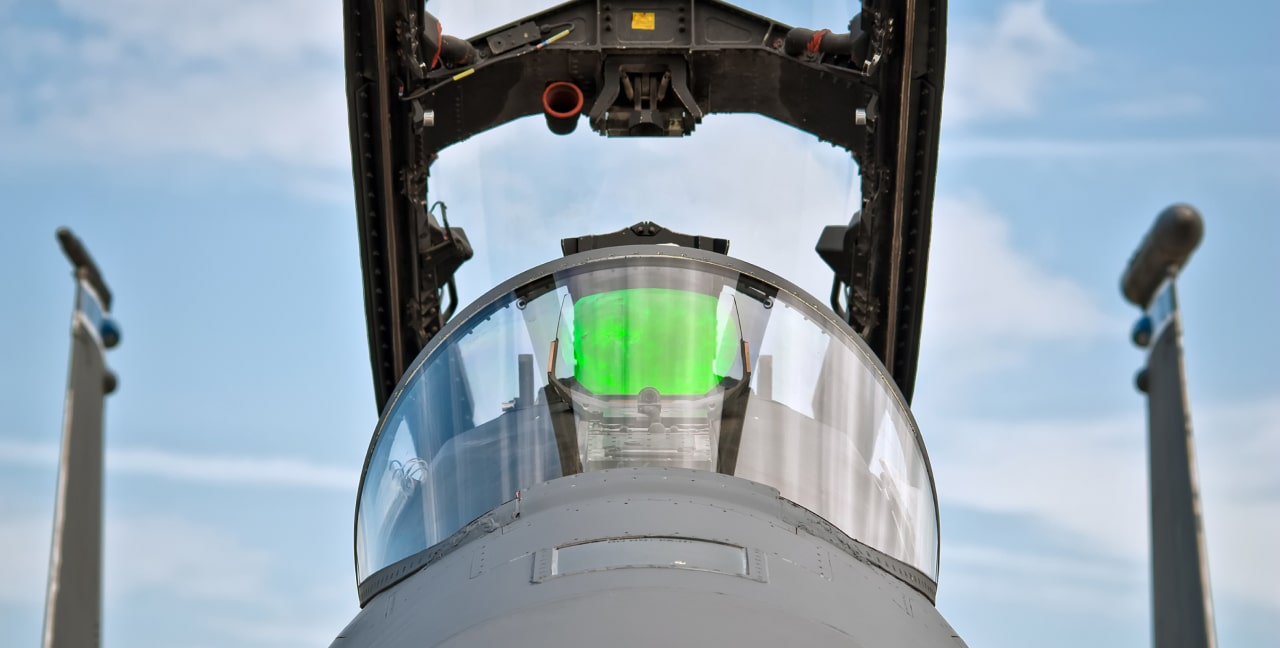 The inside of an open F-16 cockpit.