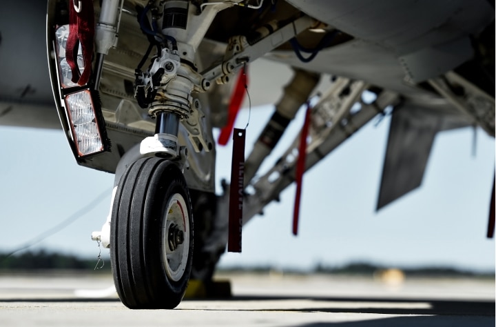 A closeup of a tire on a fighter jet.